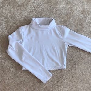 A white cropped turtle-neck sweater